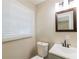 Bright bathroom with a window, toilet, sink and mirror at 264 Silver Springs Sw Cir, Atlanta, GA 30310