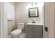 Bathroom with gray vanity and cabinets, sink, and wicker mirror at 264 Silver Springs Sw Cir, Atlanta, GA 30310