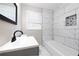 Bathroom with gray vanity, modern sink, and tiled shower wall at 264 Silver Springs Sw Cir, Atlanta, GA 30310