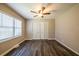 A bedroom featuring wood floors, a ceiling fan, and a window letting in light at 264 Silver Springs Sw Cir, Atlanta, GA 30310