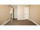 Empty bedroom with two doorways, a closet, and a window at 264 Silver Springs Sw Cir, Atlanta, GA 30310
