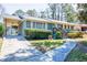 Exterior view of home featuring an attached carport, updated landscaping, and covered front entrance at 264 Silver Springs Sw Cir, Atlanta, GA 30310