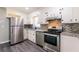 Updated kitchen with stainless steel appliances and tiled backsplash at 264 Silver Springs Sw Cir, Atlanta, GA 30310