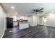 Open-concept layout with new flooring connecting a spacious living area to a kitchen with stainless steel appliances at 264 Silver Springs Sw Cir, Atlanta, GA 30310