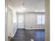 Well-lit living room featuring a new front door, updated flooring, modern lighting, and neutral paint at 264 Silver Springs Sw Cir, Atlanta, GA 30310