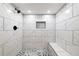 Modern tiled shower with mosaic floor, bench, and rainfall shower head at 264 Silver Springs Sw Cir, Atlanta, GA 30310