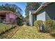Side yard featuring green grass, partial fencing, and mature shrubbery at 264 Silver Springs Sw Cir, Atlanta, GA 30310