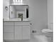 Bathroom with a black framed mirror, white vanity, and modern toilet at 2887 Hickory Ln, Snellville, GA 30078
