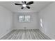 Bright bedroom with a ceiling fan, window and modern gray laminate flooring at 2887 Hickory Ln, Snellville, GA 30078