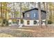 Inviting two-story home with a painted brick base and dark wood paneled second story among mature shade trees at 2887 Hickory Ln, Snellville, GA 30078