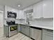 Modern kitchen with stainless steel appliances, white cabinets, and hardwood floors at 2887 Hickory Ln, Snellville, GA 30078