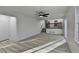 Open-concept living area with wood flooring, a ceiling fan, and access to the kitchen at 2887 Hickory Ln, Snellville, GA 30078