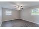 Bedroom features neutral paint, ceiling fan, modern gray flooring, and windows at 4089 Lindsey Dr, Decatur, GA 30035