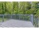 A gray, wooden deck looks out into the lush greenery of the surrounding yard at 4089 Lindsey Dr, Decatur, GA 30035