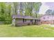 Cozy one-story home with mature trees in the background and a well-manicured lawn at 4089 Lindsey Dr, Decatur, GA 30035