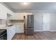 Bright kitchen features stainless steel appliances, white cabinetry, and plank flooring at 4089 Lindsey Dr, Decatur, GA 30035