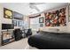 This cozy bedroom features neutral walls, black furniture, fan, carpet and decorative wall art at 1401 Keys Crossing Ne Dr, Atlanta, GA 30319