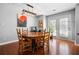 Dining room featuring hardwood floors, modern light fixture, and a round wooden table at 1401 Keys Crossing Ne Dr, Atlanta, GA 30319