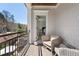 Inviting balcony with seating, overlooking a landscaped yard and tree-lined street at 557 Stone Field Nw Run, Marietta, GA 30060