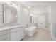 Bright, luxurious bathroom with double vanities, shiplap walls, tub, and walk-in shower at 557 Stone Field Nw Run, Marietta, GA 30060