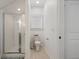 Compact bathroom featuring a glass-enclosed shower and a modern toilet at 557 Stone Field Nw Run, Marietta, GA 30060