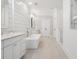 Luxurious bathroom with soaking tub, double vanities, shiplap walls, and walk-in shower at 557 Stone Field Nw Run, Marietta, GA 30060