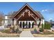 Welcoming community entrance featuring a charming wood pergola and beautifully landscaped flower beds at 557 Stone Field Nw Run, Marietta, GA 30060
