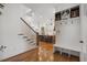 Inviting entryway with hardwood floors, a built-in bench, and views of the kitchen at 557 Stone Field Nw Run, Marietta, GA 30060