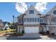 Charming townhome with stone accents, a two-car garage, and a beautifully landscaped front yard at 557 Stone Field Nw Run, Marietta, GA 30060