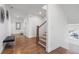 Bright foyer featuring hardwood floors, a staircase, and modern decor accents at 557 Stone Field Nw Run, Marietta, GA 30060