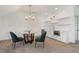 This space features a kitchenette with a glass table and sleek white cabinetry at 557 Stone Field Nw Run, Marietta, GA 30060