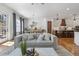 Bright open-concept living room with hardwood floors, modern lighting, and comfortable furnishings at 557 Stone Field Nw Run, Marietta, GA 30060
