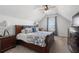 Bedroom featuring a large bed with decorative pillows, a ceiling fan, and ample natural light at 557 Stone Field Nw Run, Marietta, GA 30060