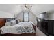 Bright bedroom featuring a bed, ceiling fan, and a dresser at 557 Stone Field Nw Run, Marietta, GA 30060