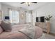 Comfortable main bedroom with windows, soft lighting, a TV, and stylish decor at 557 Stone Field Nw Run, Marietta, GA 30060
