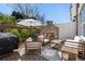Inviting patio with outdoor fireplace, comfortable seating, and lush landscaping at 557 Stone Field Nw Run, Marietta, GA 30060
