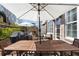 Spacious patio with ample seating, an outdoor fireplace, and serene backyard view at 557 Stone Field Nw Run, Marietta, GA 30060