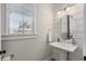 Charming powder room with shiplap walls, pedestal sink, and stylish fixtures at 557 Stone Field Nw Run, Marietta, GA 30060