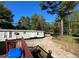 Backyard featuring a trailer and a parked car on the driveway at 615 Woodruff Rd, Carrollton, GA 30116
