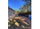 View of the backyard and covered parking area for this country home on a sunny day at 615 Woodruff Rd, Carrollton, GA 30116