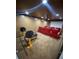 Basement with a movie screen, workout equipment, a projector, and red lounge chairs at 615 Woodruff Rd, Carrollton, GA 30116