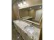 Bathroom vanity featuring double sinks and a large mirror at 615 Woodruff Rd, Carrollton, GA 30116