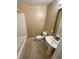 Bathroom featuring a white sink, toilet, and a bathtub with tile flooring at 615 Woodruff Rd, Carrollton, GA 30116
