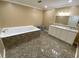 Bathroom featuring vinyl floors, tub, and double sink vanity at 615 Woodruff Rd, Carrollton, GA 30116