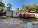 Exterior view of home with a large wooden deck and gravel driveway at 615 Woodruff Rd, Carrollton, GA 30116