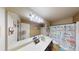 Bathroom with a shower curtain and a large mirror with a single sink vanity at 2409 Brynfield Cv, Suwanee, GA 30024