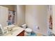 Cozy bathroom featuring a single sink vanity, a toilet, and a shower with a decorative curtain at 2409 Brynfield Cv, Suwanee, GA 30024