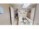 Bathroom vanity with dual sinks and mirror, adjacent to the hallway at 2409 Brynfield Cv, Suwanee, GA 30024