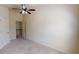 Empty bedroom with ceiling fan, neutral carpet, and access to the upper level at 2409 Brynfield Cv, Suwanee, GA 30024
