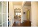 Welcoming entryway with hardwood floors and archways leading to the living spaces at 2409 Brynfield Cv, Suwanee, GA 30024
